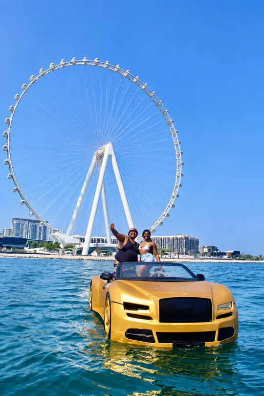 Gold Jet Car on the water with Ain Dubai behind it