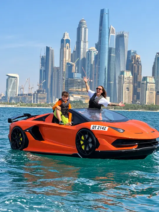 Guests in an orange Jet Car with the Marina skyline behind them